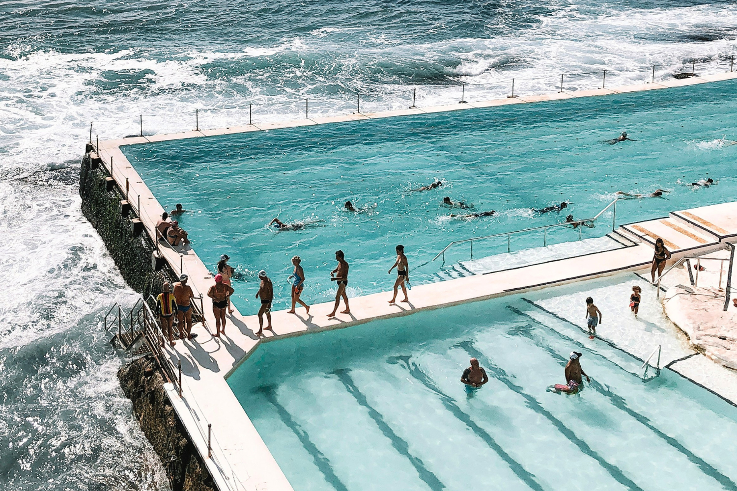 Travellers swimming in Bondi Beaches iconic iceberg pools, near Sydney in Australia