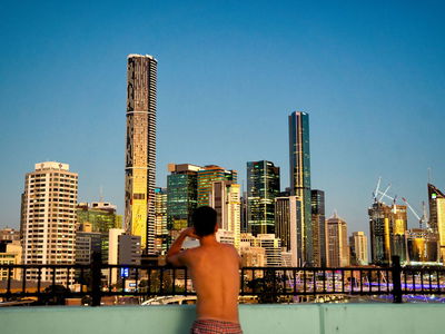 Person looking over Brisbane Skyline at night