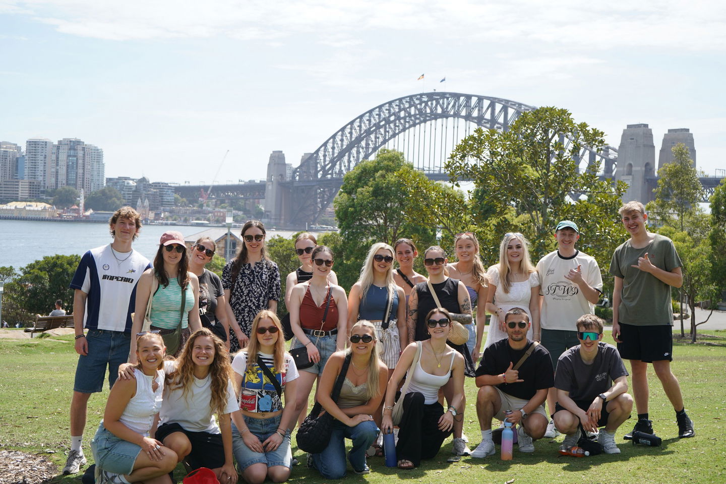 Group of travellers stood in front of the Sydney Harbour Bridge