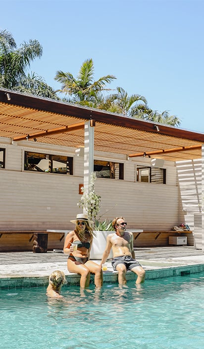 Travellers sat by pool at Wakeup hostel