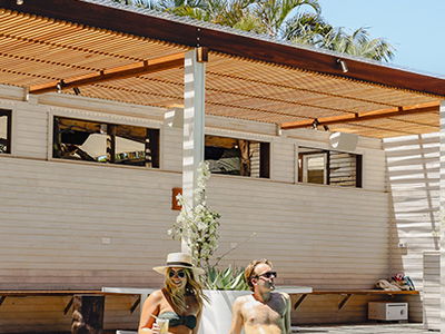 Travellers sat by pool at Wakeup hostel