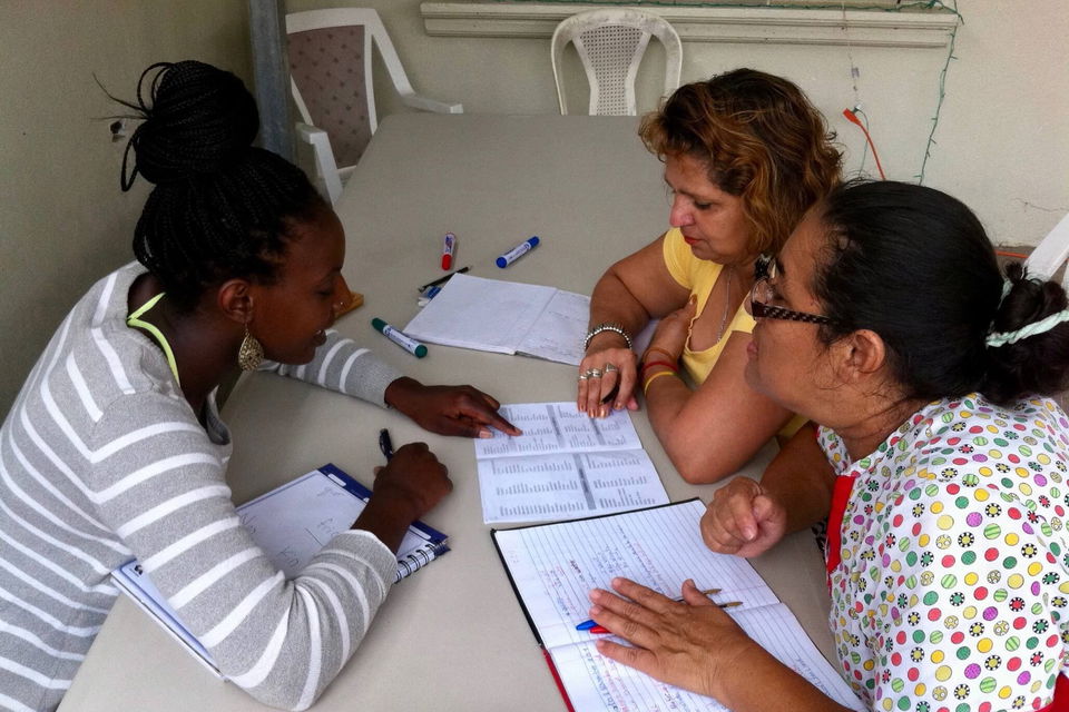 Teacher with two adult students