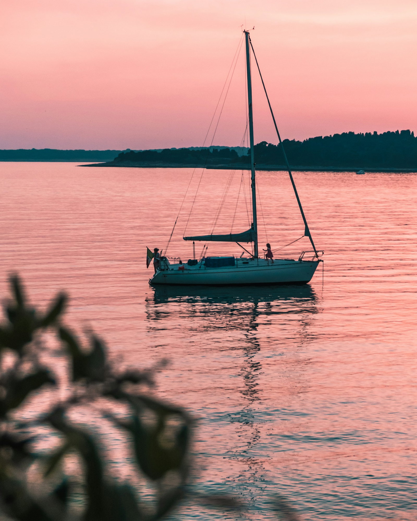 Traditional Croatian sailboat at pink sunset