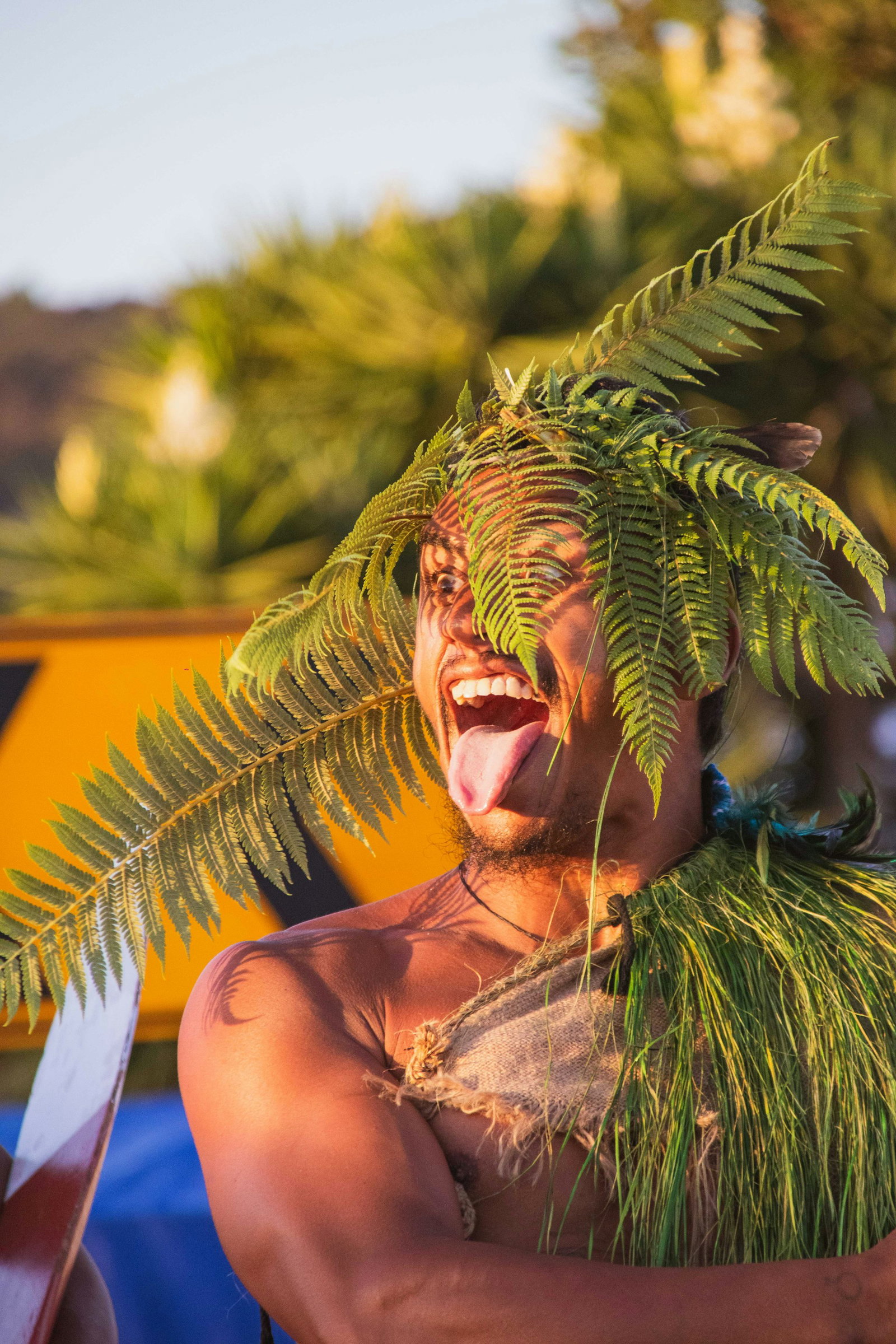 Māori man performing the Haka in traditional clothing
