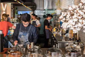 People working at a barista in a coffee shop in Sydney, Australia