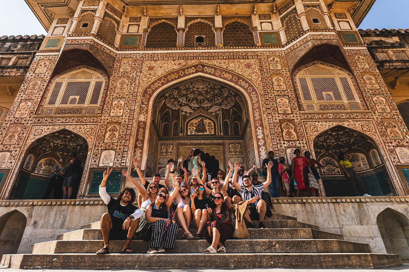 Group of travellers posing in front of Amber Fort in Jaipur
