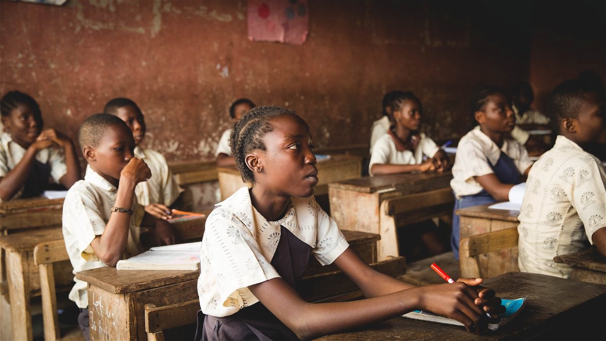 African schoolkids sitting at their desks in a classroom