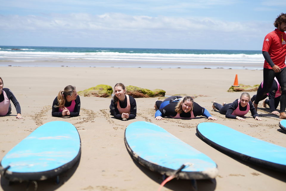 Group learning to surf on beach at Mornington Peninsula