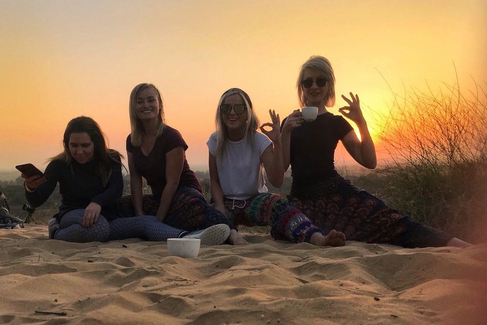 Group travellers drinking tea in the desert in India