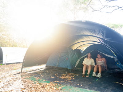 People sat in tents in Kgari camping accommodation