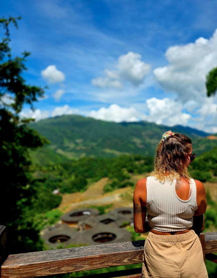 Traveller overlooking Chinese countryside and traditional Fujian Tulou houses