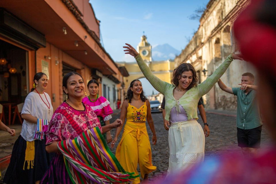 Travellers dancing down street in Antigua