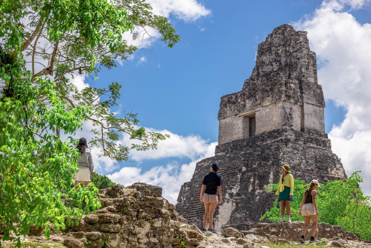 Group of travellers at the ancient city of Tikal
