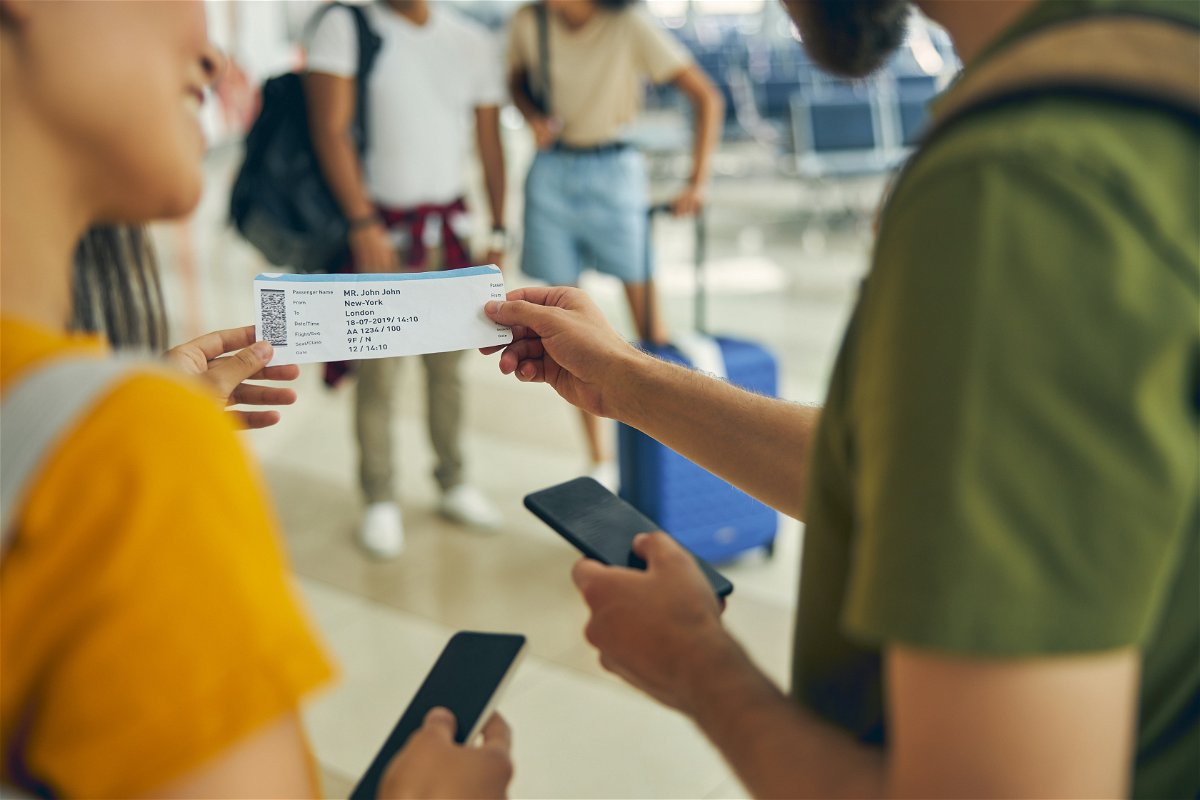 Travellers holding plane ticket