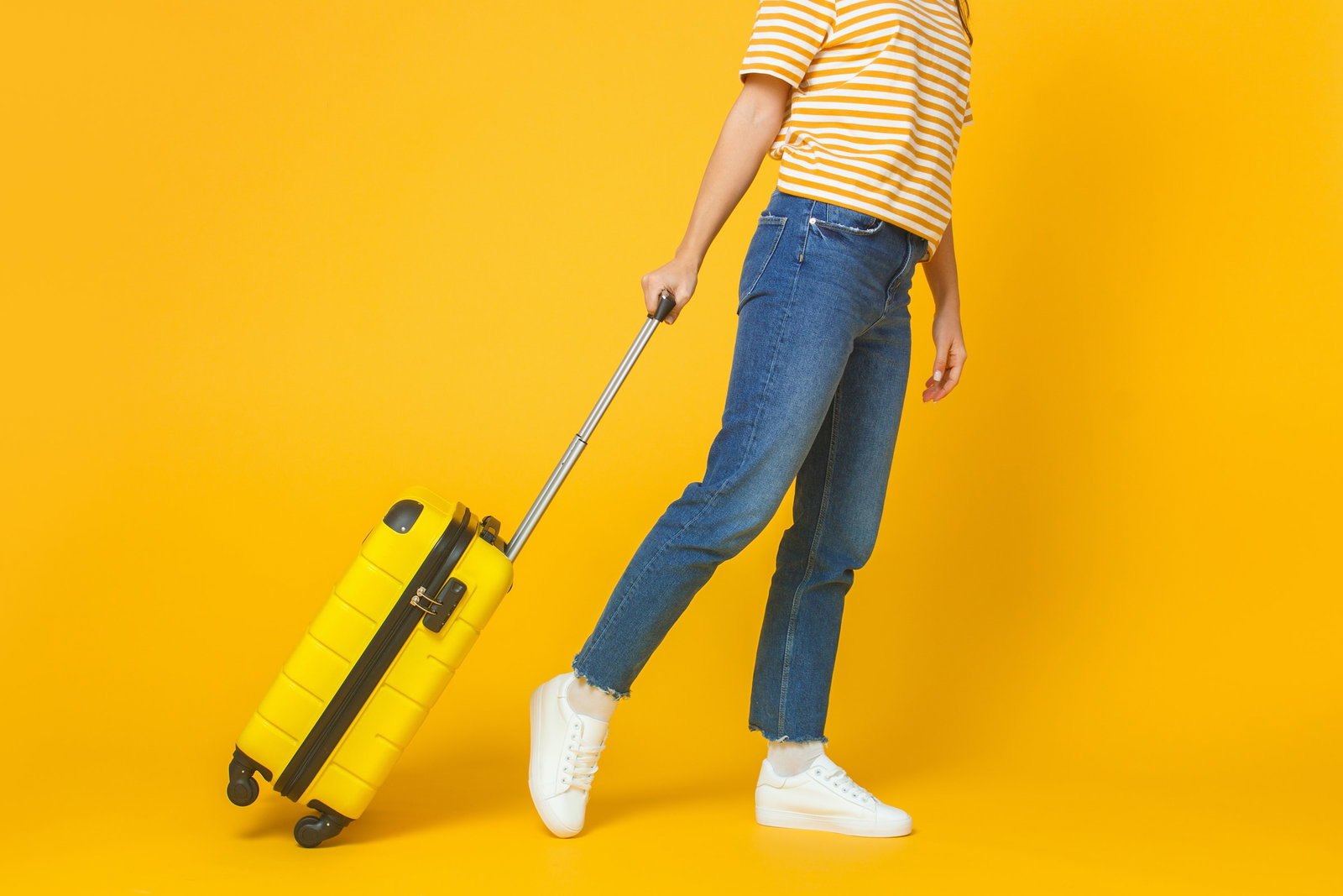 Traveller with a yellow suitcase
