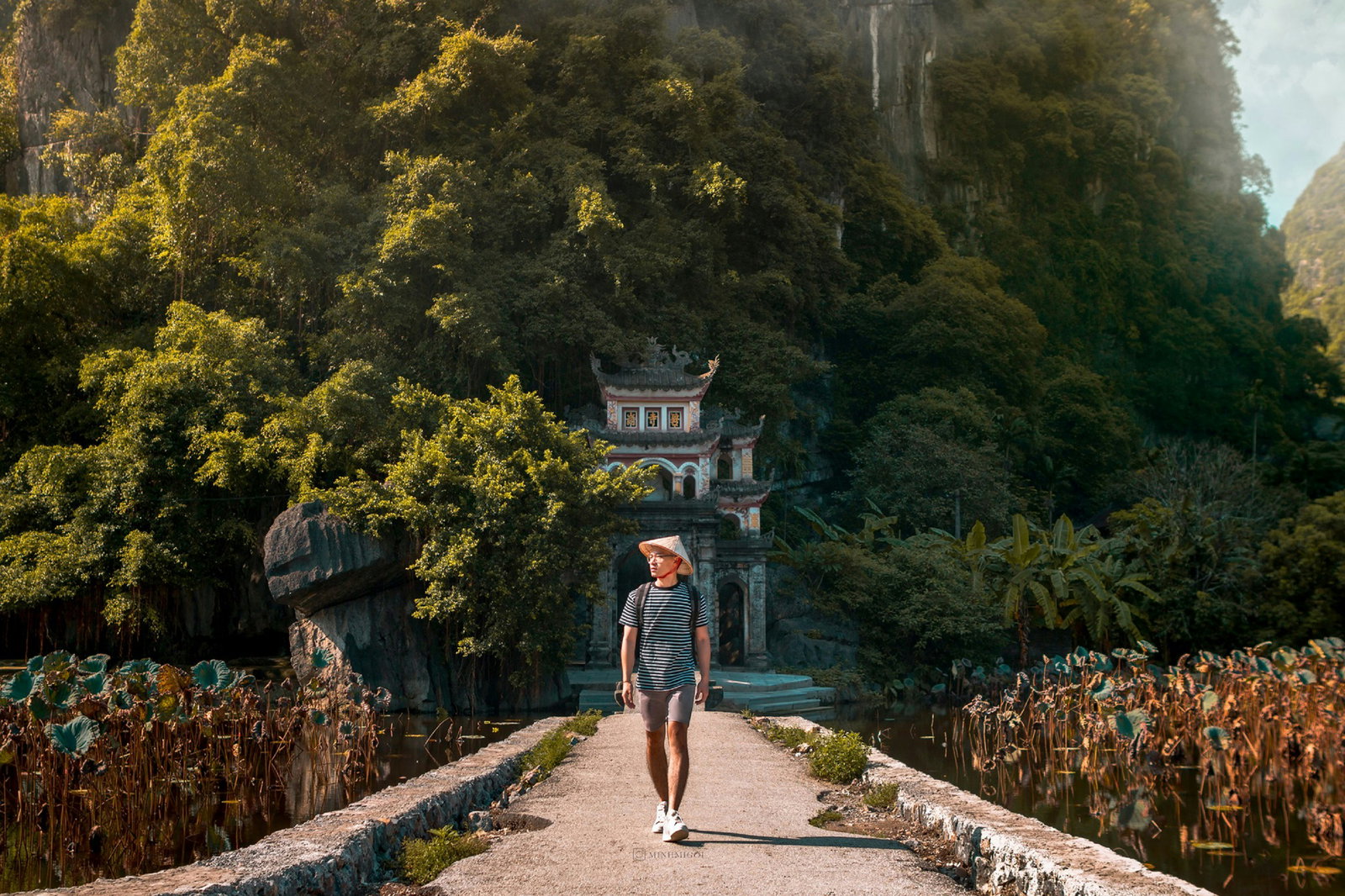 Traveller walking along a path in the Trang An Scenic Landscape Complex