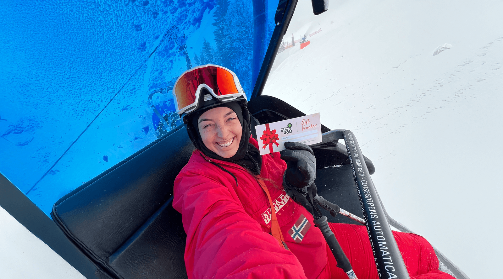 Group traveller holding travel gift voucher in Austria on ski lift