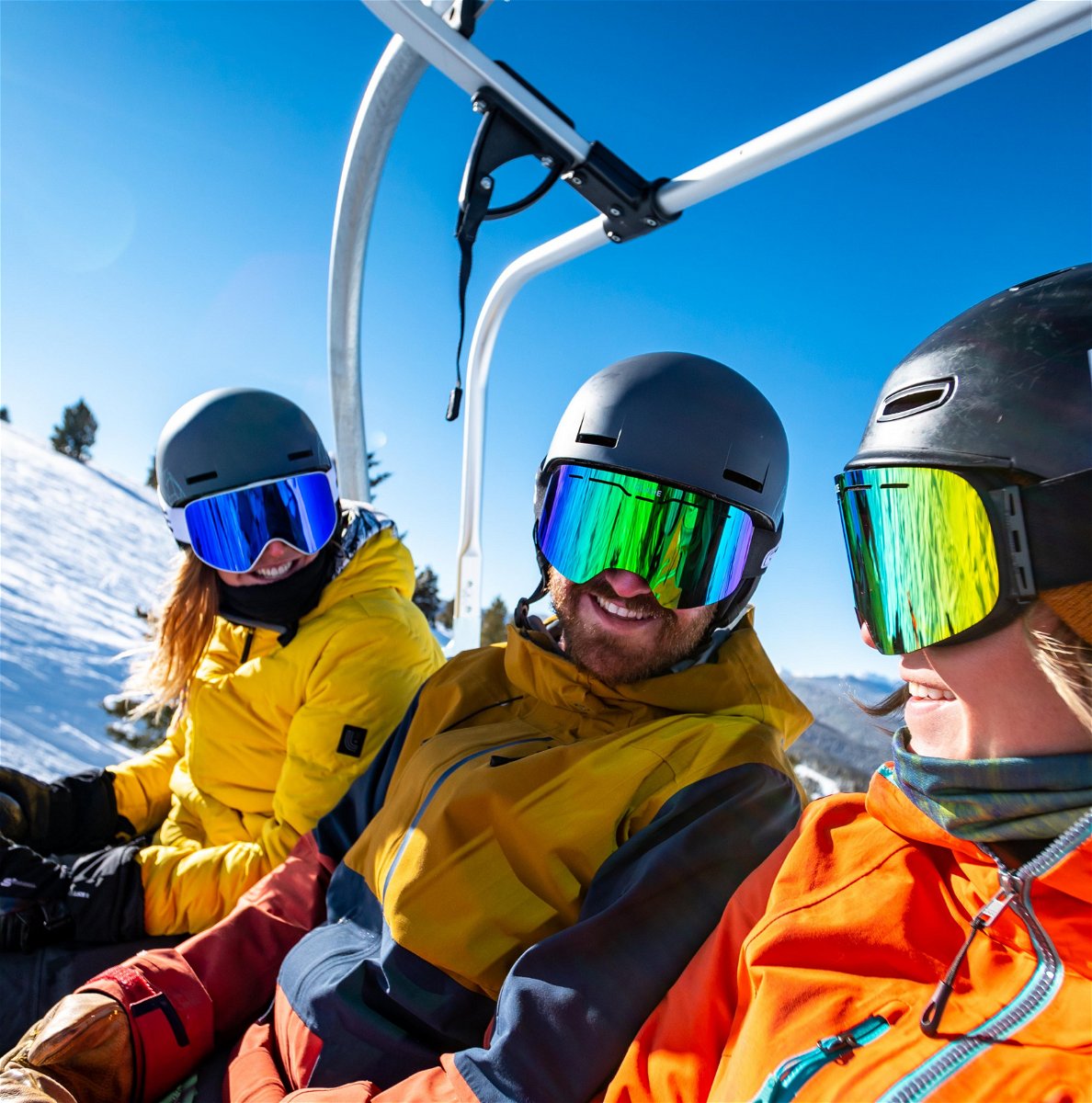 3 people sat on a ski lift