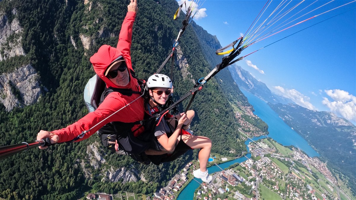 Traveller paragliding over Interlaken, Switzerland