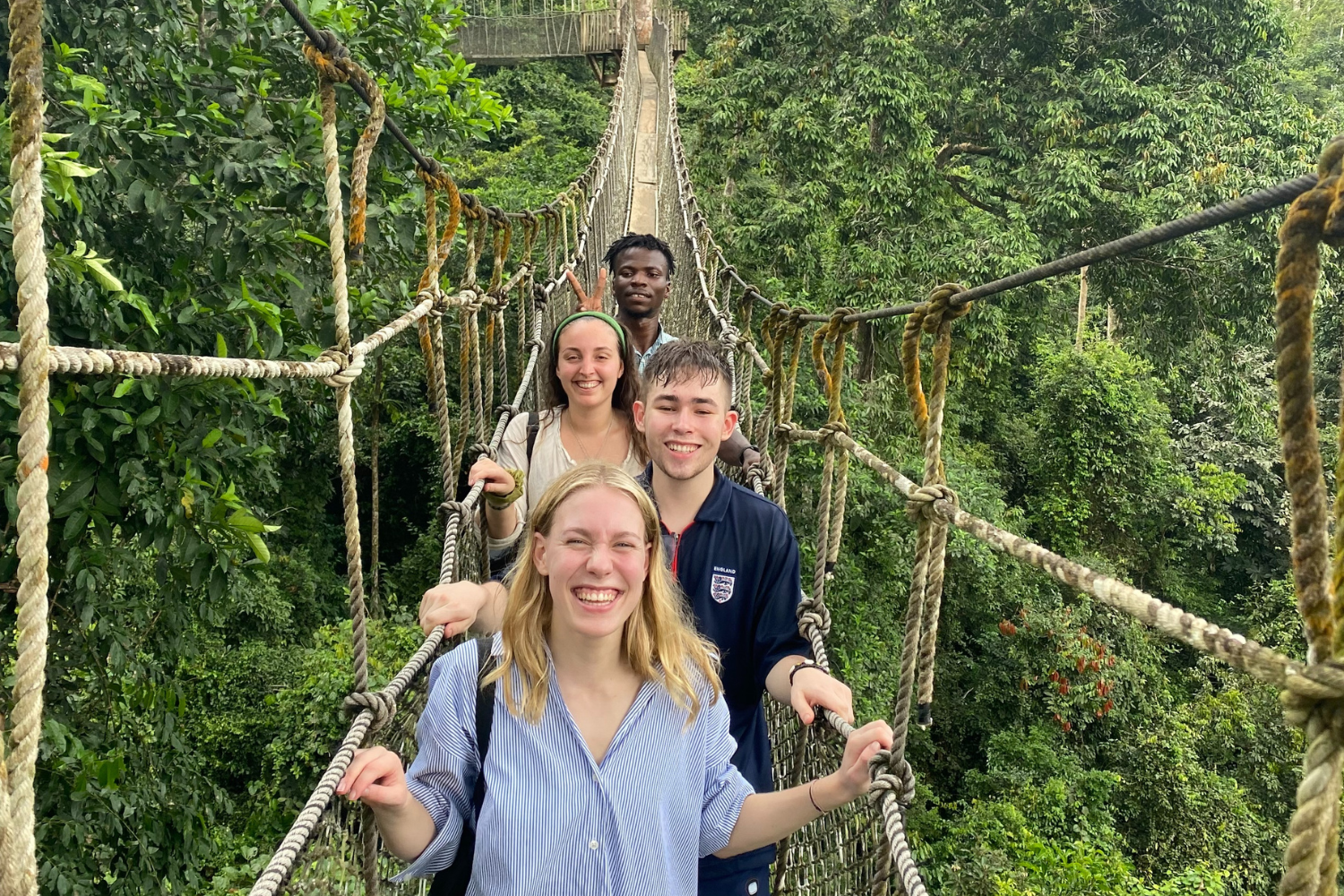 Group of travellers walking across the canopy walkway in Kakum National Park