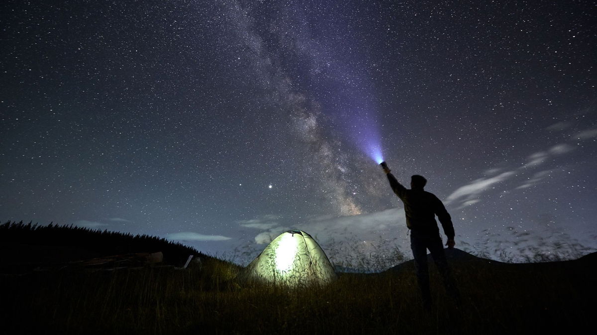 Traveller at camp site looking at the stars