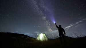 Traveller at camp site looking at the stars