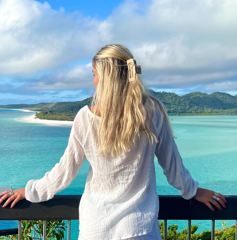 Traveller looking out at Whitehaven Beach in the Whitsunday Islands