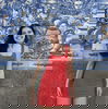 Woman in red dress in front of blue tiled building, Porto, Portugal