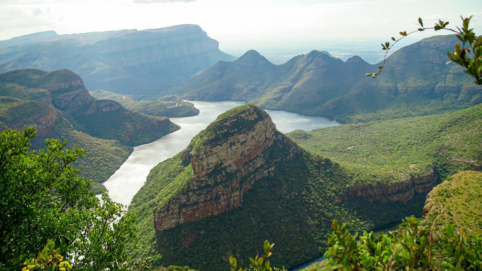 Emerald vista with curved rocks clad with jungle landscape and intersected by wide winding river, Panorama Route South Africa