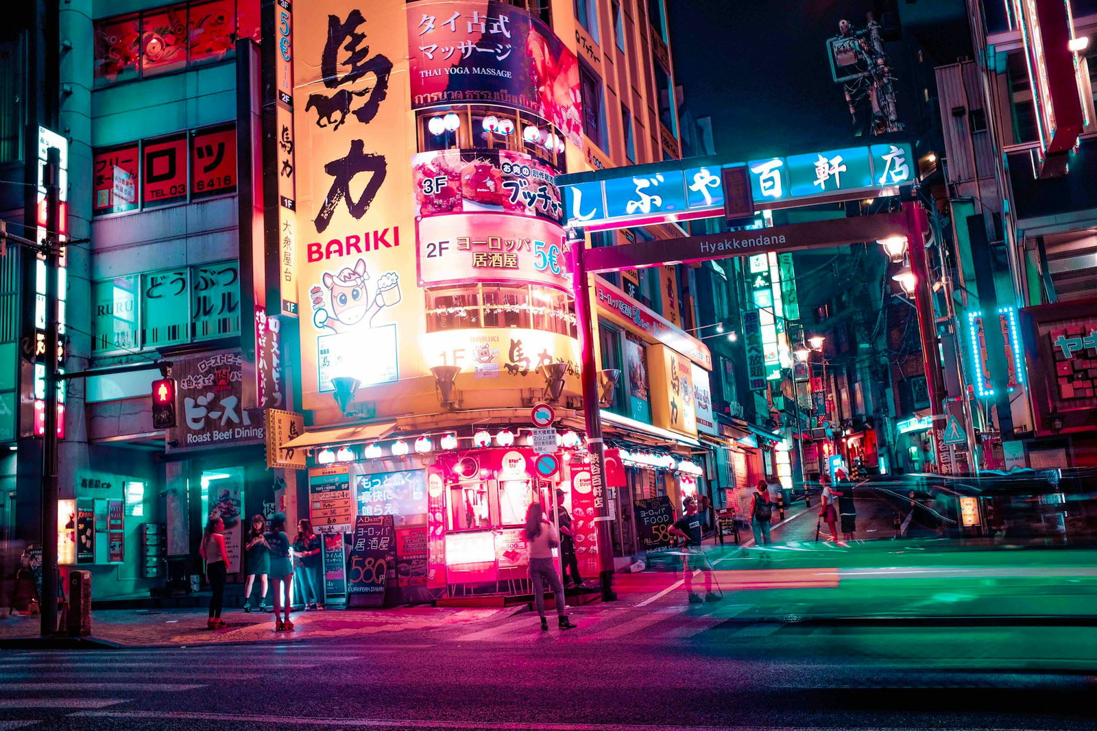 Neon billboards in neon-lit Tokyo street at night
