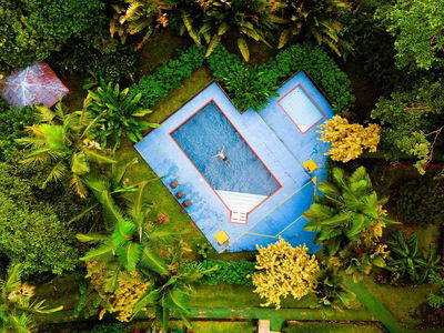 Drone image of a swimming pool near rainforest in Costa Rica