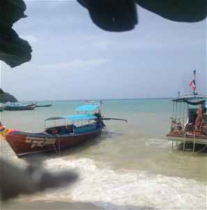 Boats on the shore of a Thailand beach
