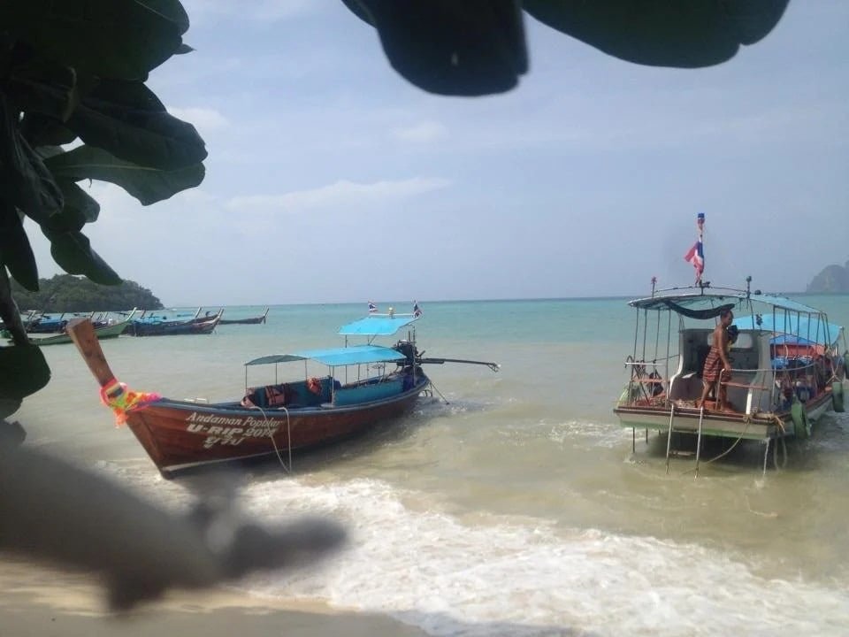 Boats on the shore of a Thailand beach