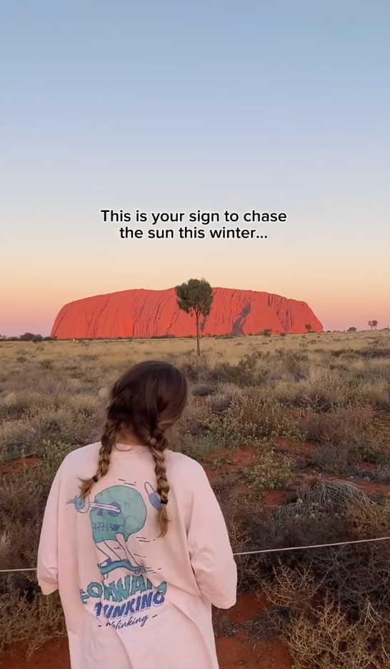 Traveller looking at Uluru Rock