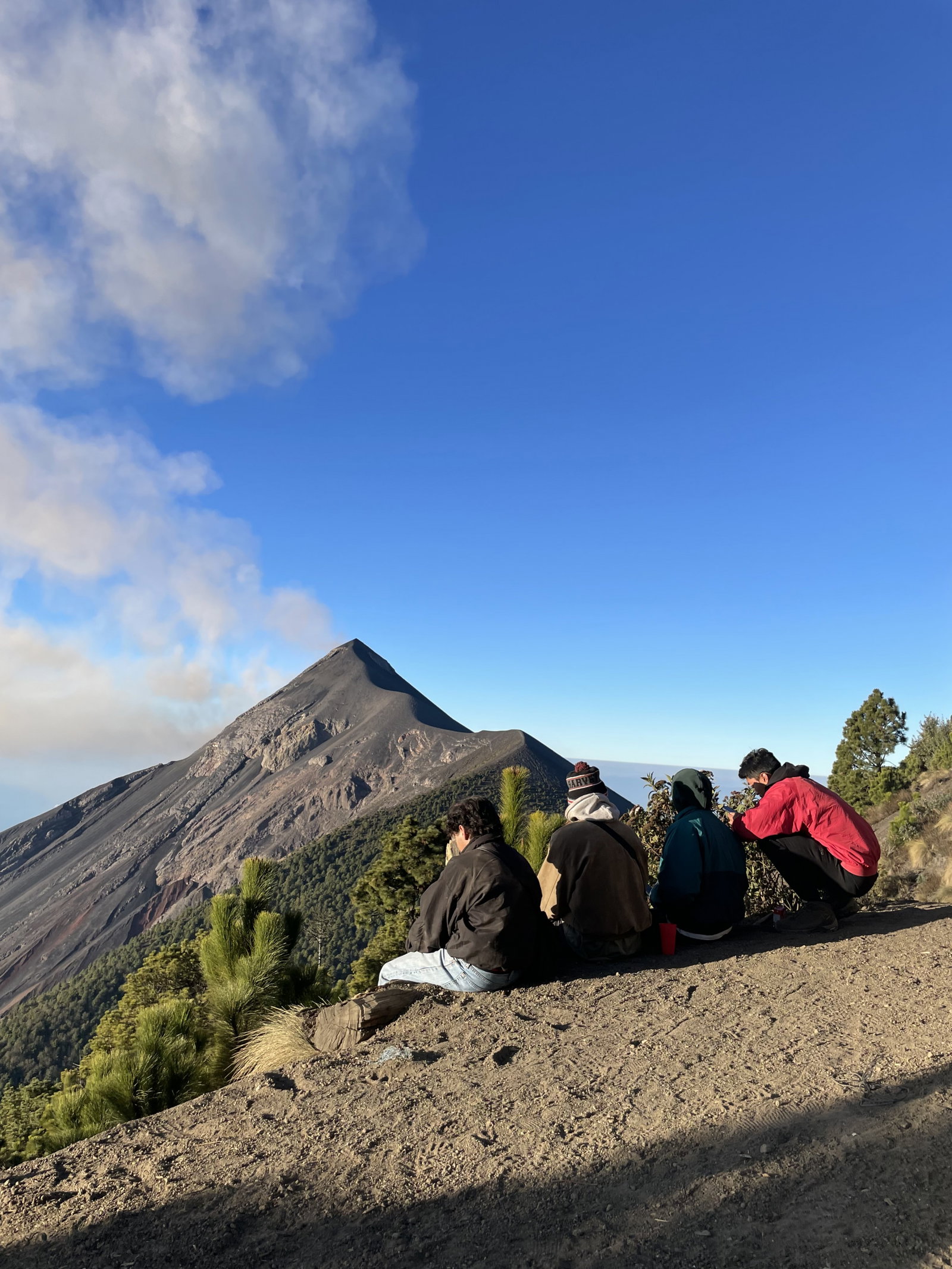 Travellers on sat down overlooking volcano in Guatemala