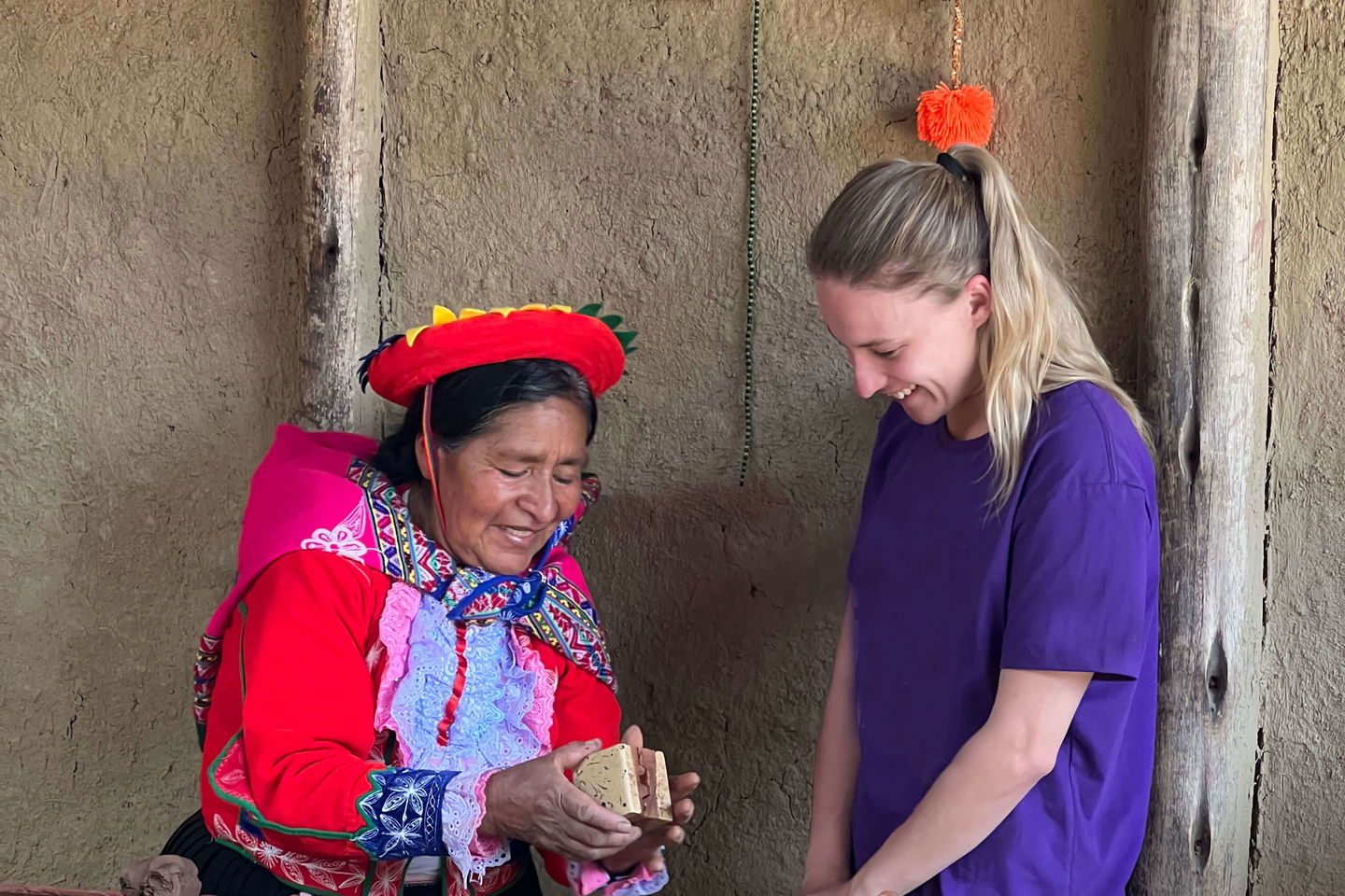 Group traveller with Peruvian woman making pottery in Cusco Peru