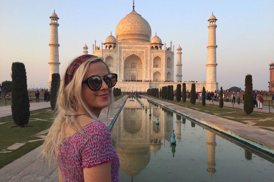Group traveller on 18-30s group tour looking over taj mahal in agra india