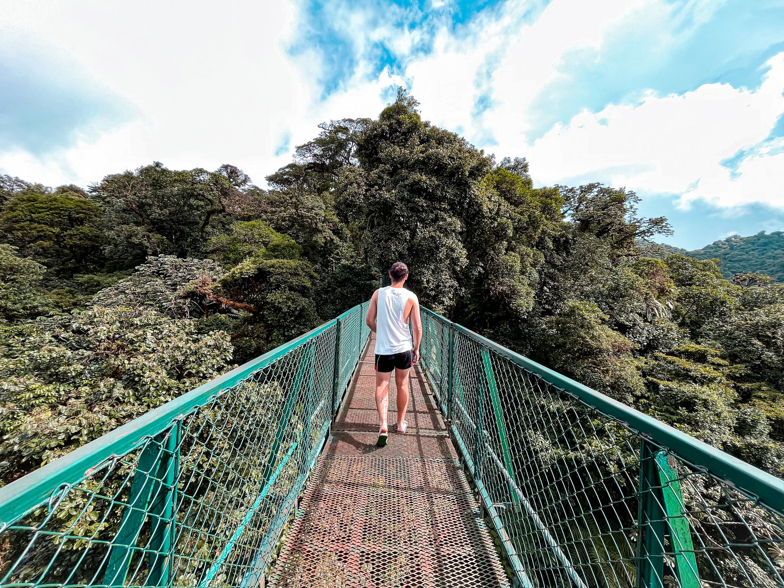 Traveller walking over suspension bridge in Costa Rica