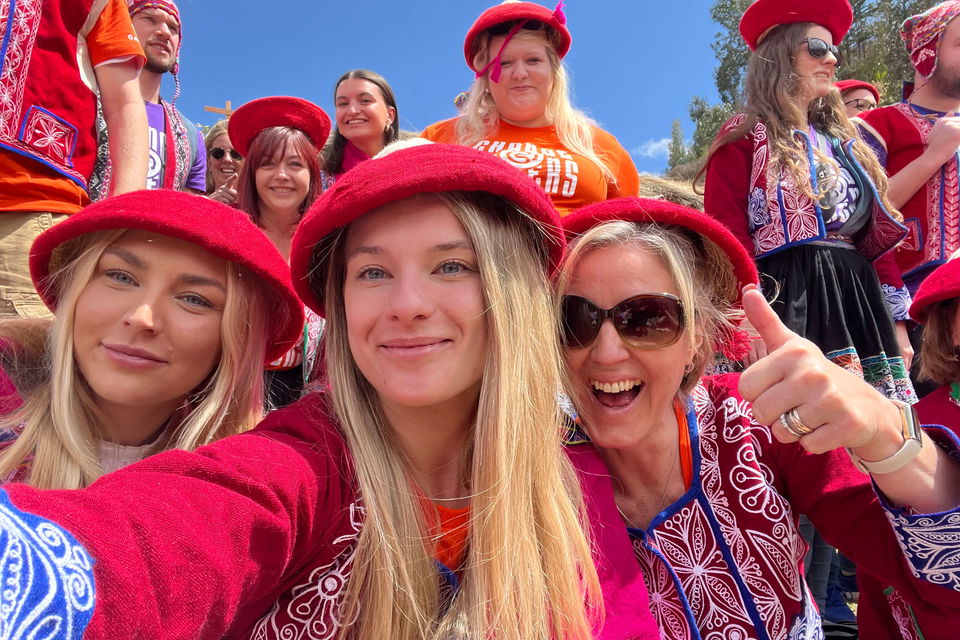 Group travellers in traditional Peruvian clothes at Cusco Peru