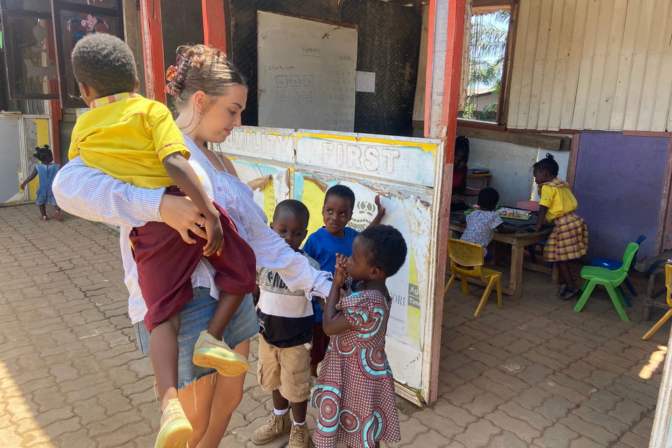 Teacher with students in ghana classroom
