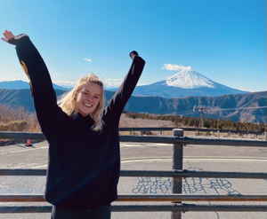 Traveller with hands up in front of Mount Fuji, Japan 