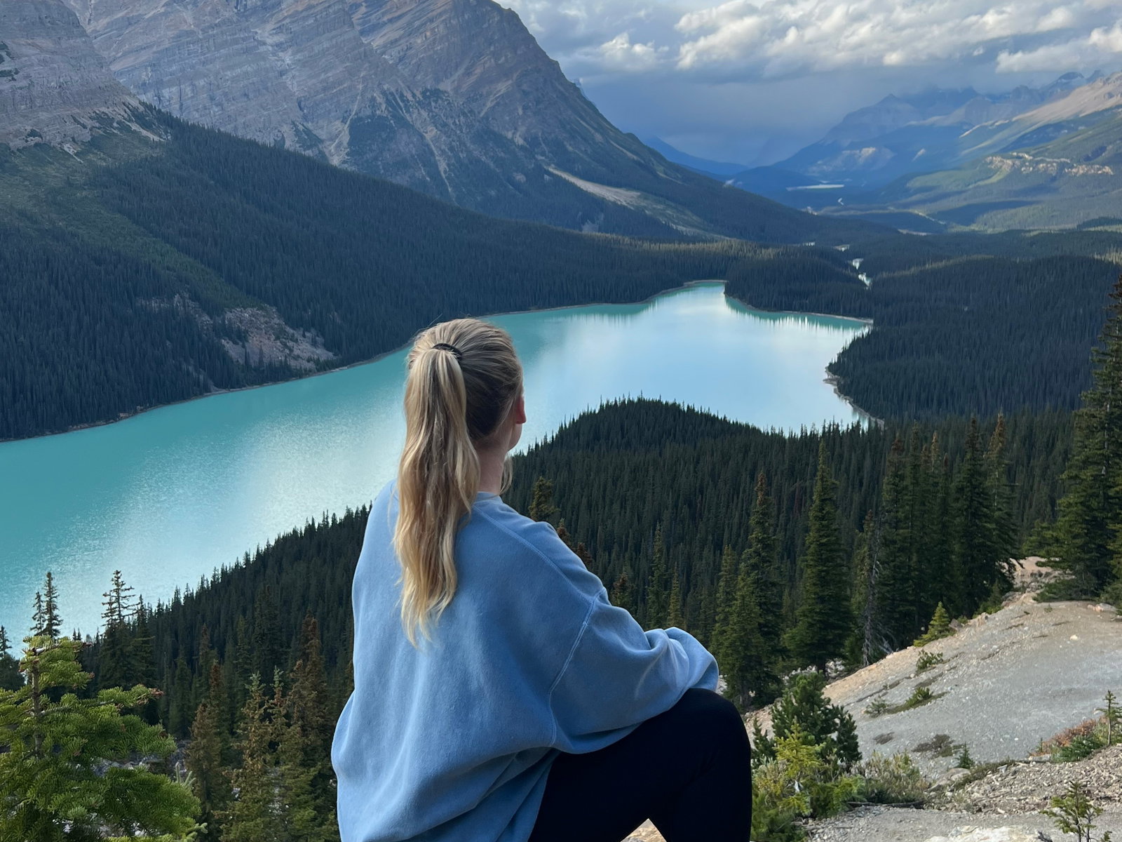Person sat on rock looking out at Lake Louise