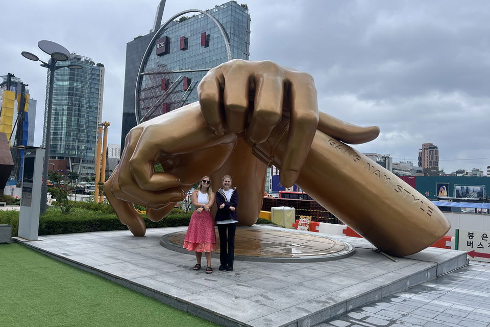 Travellers at Gangnam style statue in south korea