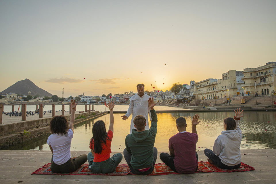 Group travellers in pushkar at lake at sunset