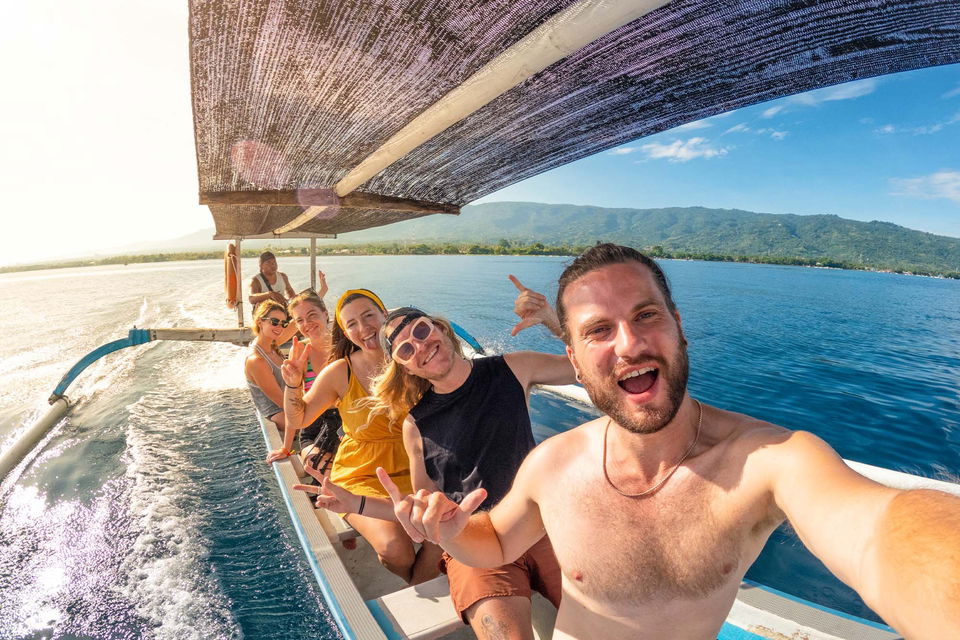 Travellers taking a selfie on a dolphin boat ride in Lovina