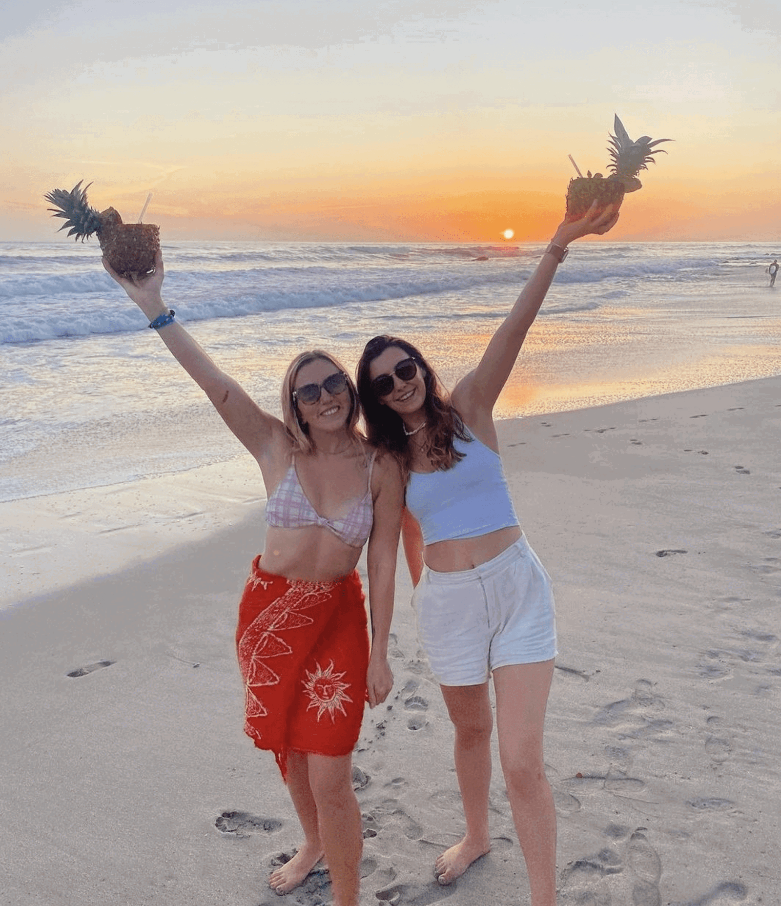 Group travellers holding pineapple drinks in Costa Rica 