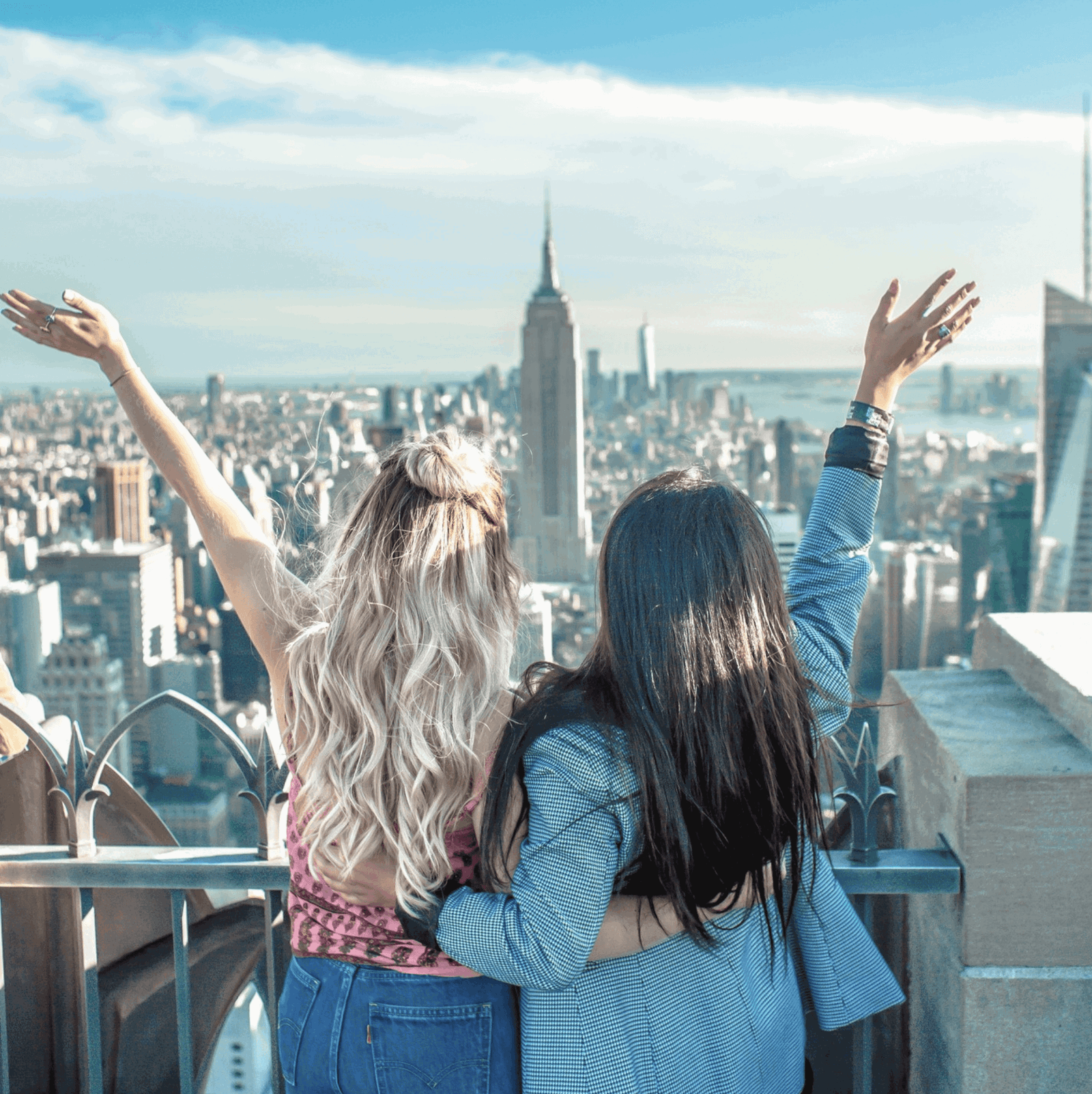 Group travellers looking over New York skyline at Empire State Building