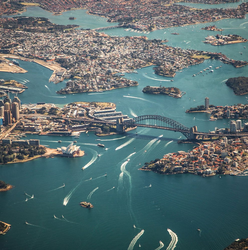 Aerial view of the Sydney Harbour Bridge and surrounding bay and city