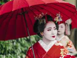Geisha holding a red parasol