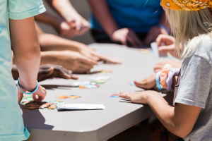 A group of children at a table putting a puzzle together